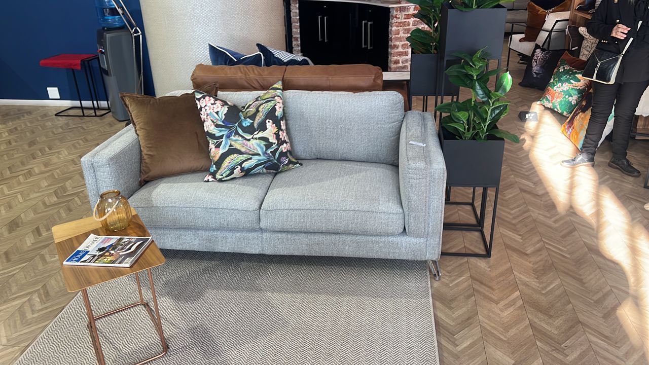 Modern gray fabric sofa with decorative pillows